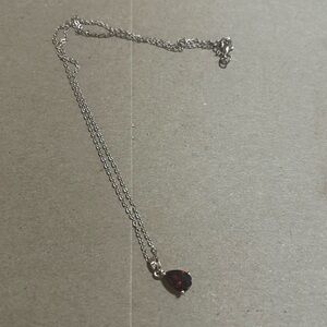 Gold chain with a ruby red stone piece